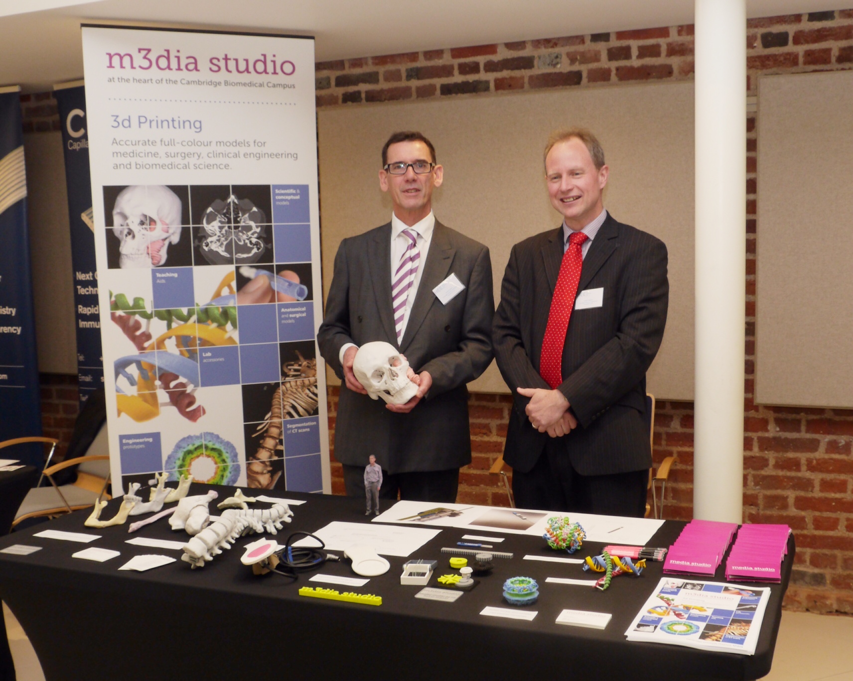 Jerry Nayler and James Hallinan with the Media Studio 3d Printing exhibition stand with anatomical, engineering and biochemical structural models